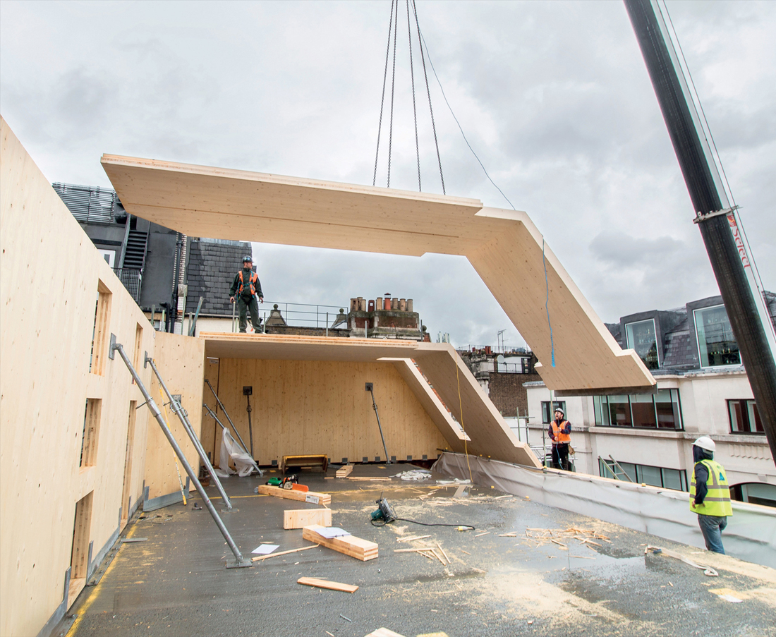 FIG 10.0 (chapter opener) Mansard roof panels being lifted into position on a constricted site using a mobile crane to create valuable new top floor mezzanine volumes atop an existing listed structure (Lower James Street, London by Hale Brown Architects with Heyne Tillett Steel Engineers, 2016).