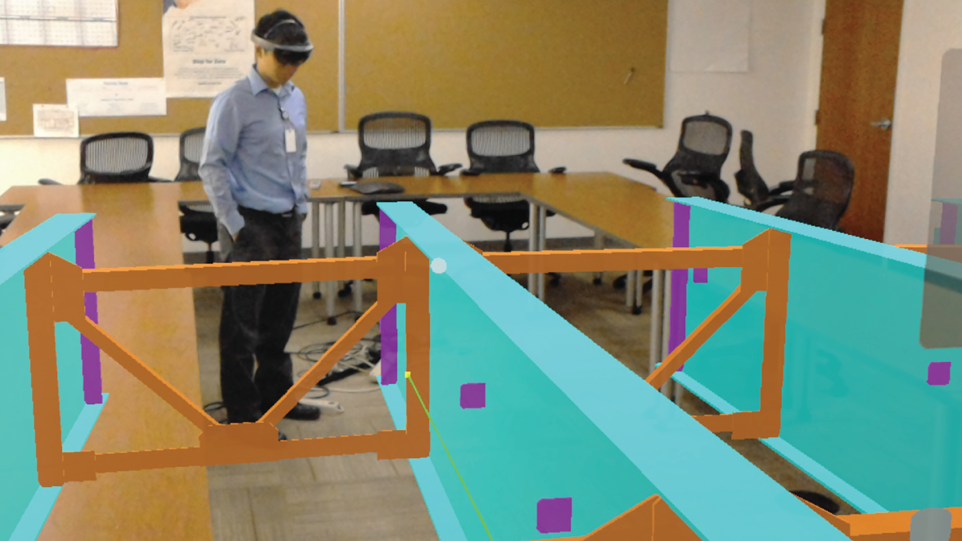 Photograph depicting engineers  visualizing connection details using up-to-date design models of augmented reality.