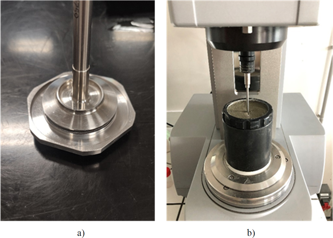 A photograph of a silver espresso machine placed on a kitchen counter. It is categorized as a small home appliance, specifically designed for making coffee. The figure also includes types of test geometry used to study the flow of cementitious materials, such as parallel plate and coaxial geometry.