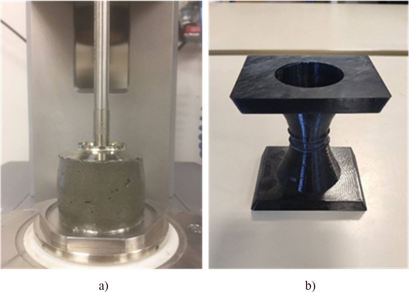 Two test geometries for studying the elongation behaviour of materials. Image (a) shows a simple compression test, where a cylindrical sample of a grey material is placed on a platform. Image (b) shows a tensile test device, which is a black, 3D-printed object with a square base and a conical top.